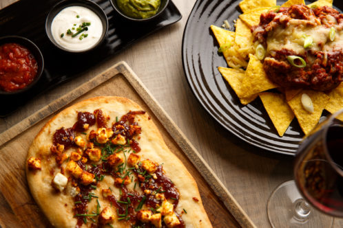 chilli nachos, cheese, dips, bread and wine