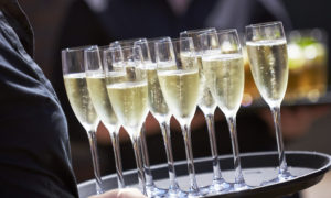 Tray of Champagne drinks being served on a sunny day outdoors