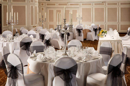 The Almond Suite at Mercure Livingston Hotel, set up for a wedding breakfast, white and grey, silver candlestick centrepieces