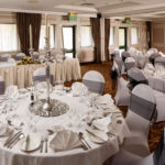 The Almond Suite at Mercure Livingston Hotel, set up for a wedding breakfast, white and grey, silver candlestick centrepieces