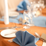 Detailed shot of folded light blue napkin place setting, wedding breakfast