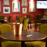 The bar area in Mercure Livingston Hotel, close up of rose wine on table