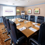 The Boardroom at Mercure Livingston Hotel, set up for a meeting, projector screen