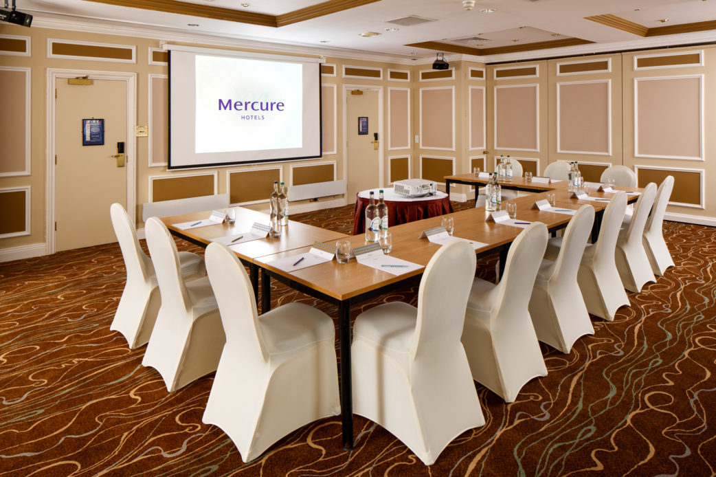 The Burn Suite at Mercure Livingston Hotel, set up for a meeting, projector screen