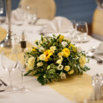 Floral centrepiece on table, wedding breakfast, yellow flowers