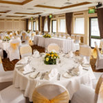 The Gillian Suite at Mercure Livingston Hotel, set up for a wedding breakfast, white and yellow theme