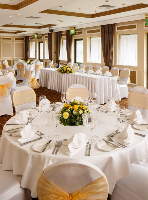 The Gillian Suite at Mercure Livingston Hotel, set up for a wedding breakfast, white and yellow theme
