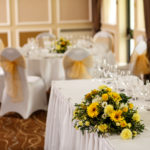 Close up view of top table in the Gillian Suite at Mercure Livingston Hotel, set up for a wedding breakfast, white and yellow theme