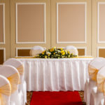 The Gillian Suite at Mercure Livingston Hotel, set up for a wedding ceremony, white and yellow theme, red carpet aisle