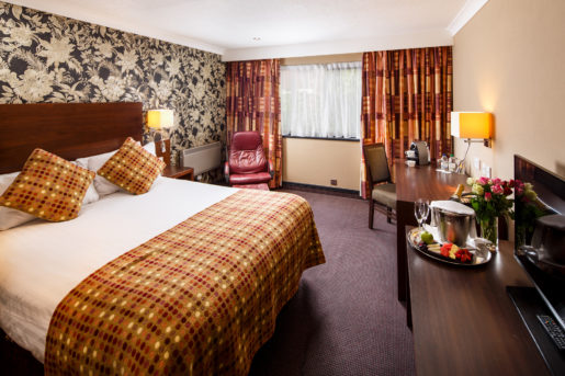 Privilege bedroom at Mercure Livingston Hotel, pink roses & champagne on desk