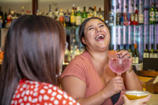 Two ladies sitting and drinking